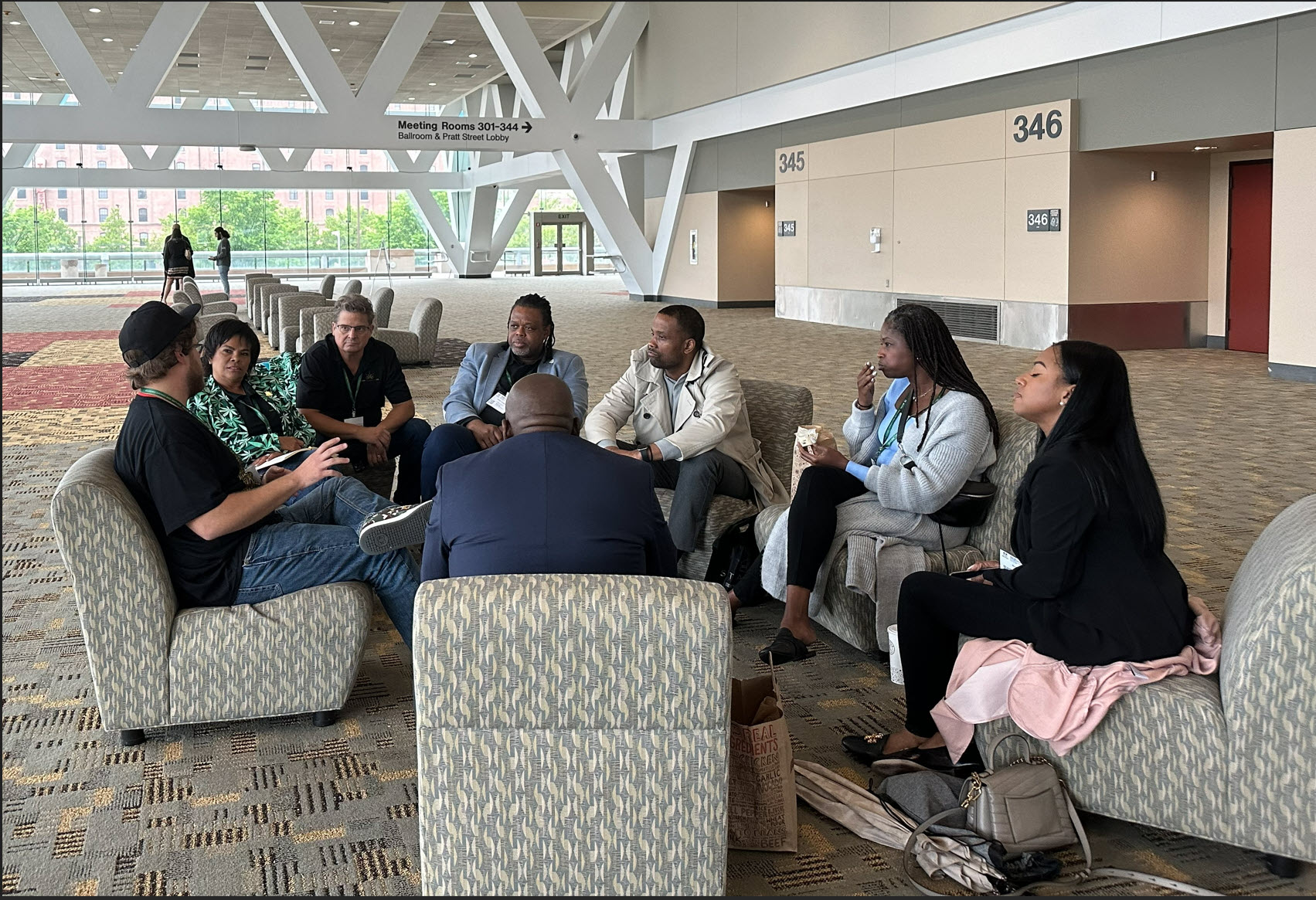 ILoveCompliance team members and industry colleagues in a group discussion at a conference