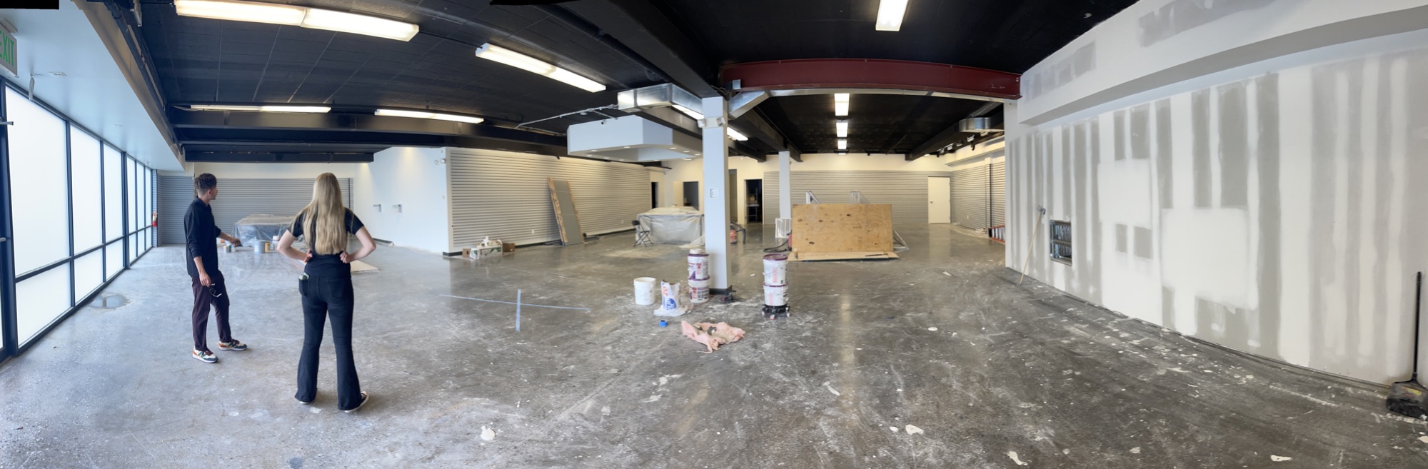 Two people reviewing an unfinished cannabis facility