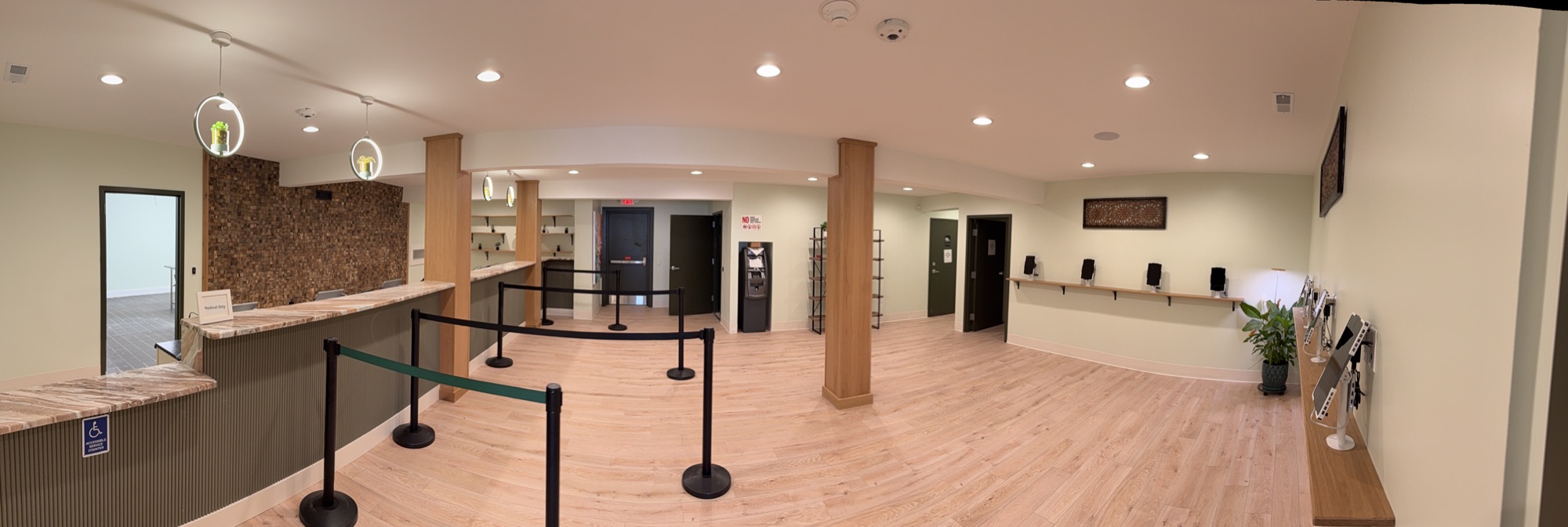 Wide view of a dispensary floor with security cameras visible